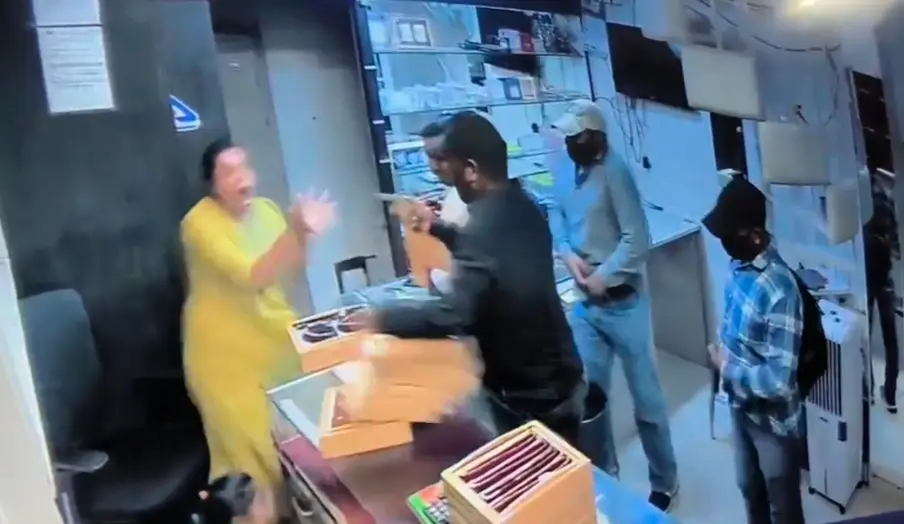 Woman Jewelry Shop Owner Jumps Over Counter to Chase Away 6 Armed Robbers